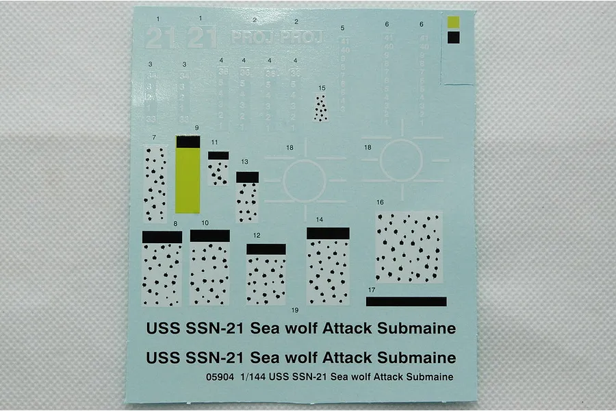 A decal sheet for a 1/144 scale Trumpeter USS Seawolf SSN-21 model kit, featuring various markings, numbers, and text on a light blue backing paper.