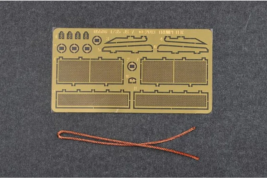 A photo-etched brass fret and a length of copper wire for a 1/35 scale Trumpeter JS-7 tank model kit.