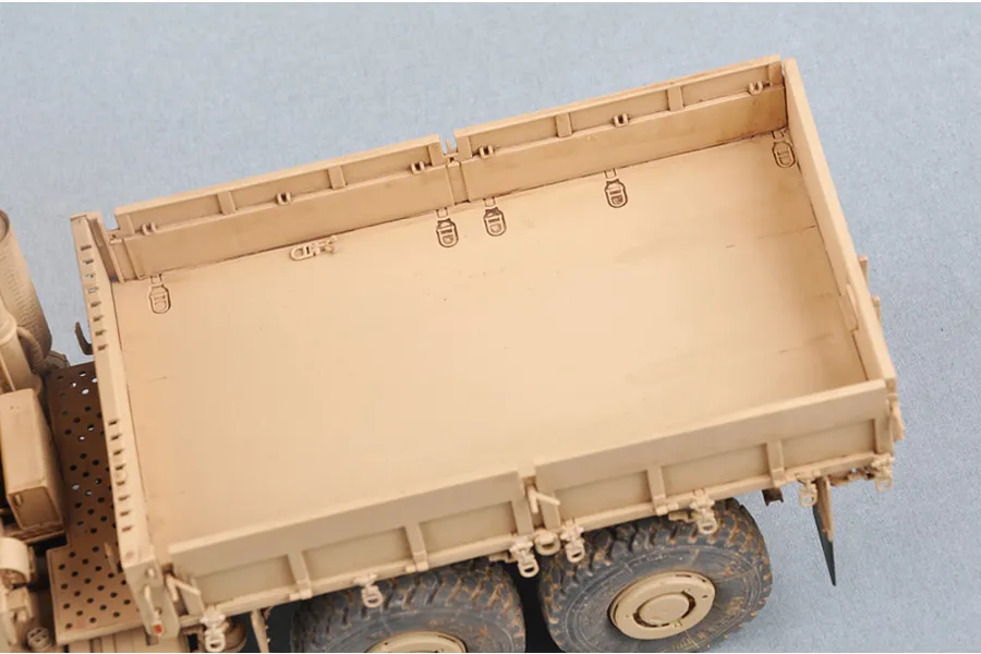 High-angle view of the tan cargo bed of a 1/35 scale Trumpeter MK.23 MTVR military truck model kit.