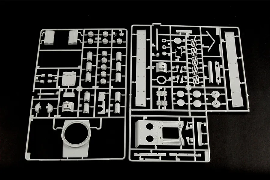Two grey plastic model kit sprues containing various tank parts on a black background.