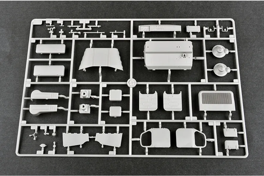 A grey plastic model kit sprue containing various vehicle parts for a 1/35 scale military model.