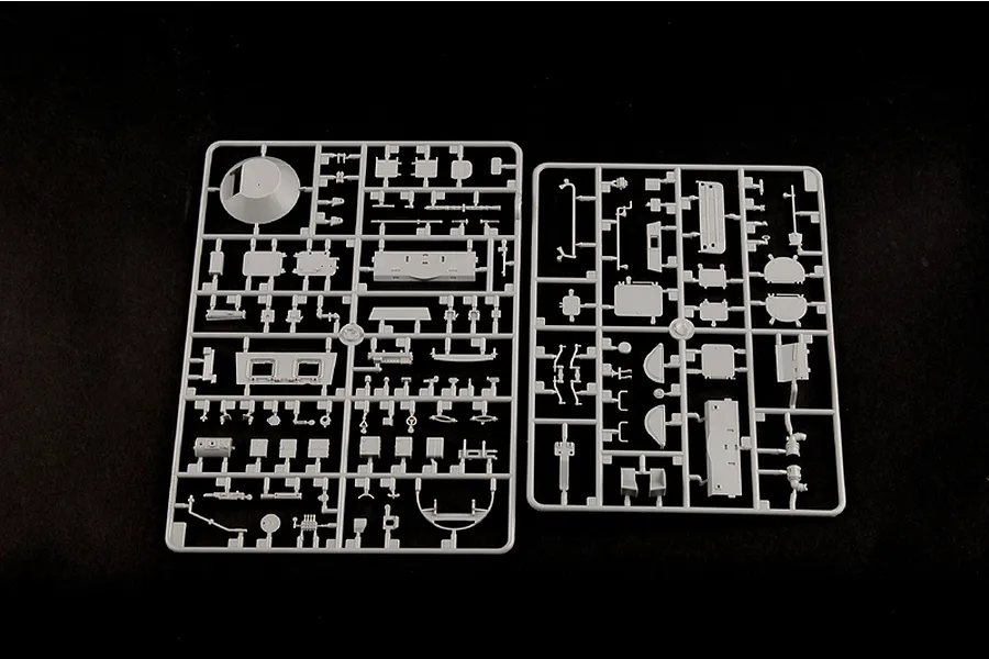 Two grey plastic model kit sprues containing various vehicle parts for a 1/35 scale BTR-60PB model, laid out on a black background.