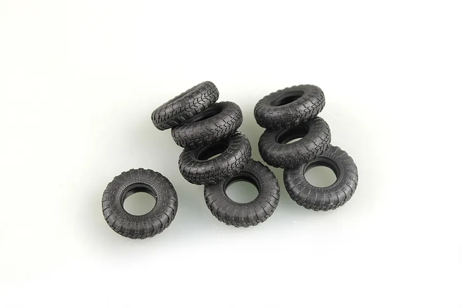 A cluster of eight black rubber model vehicle tires with detailed tread patterns on a white background.