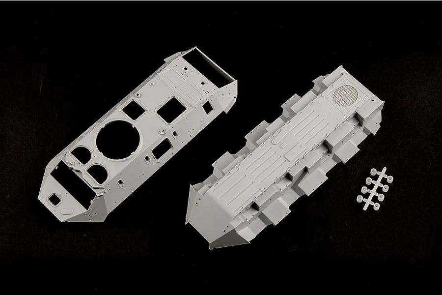 Unassembled grey plastic model kit parts for a BTR-60PB armoured vehicle, including the upper and lower hull sections.