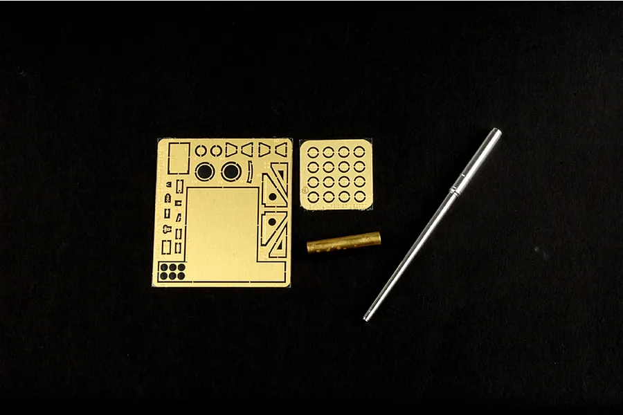 Photo-etched brass detail parts and metal gun barrel components for a 1/35 scale model kit on a black background.