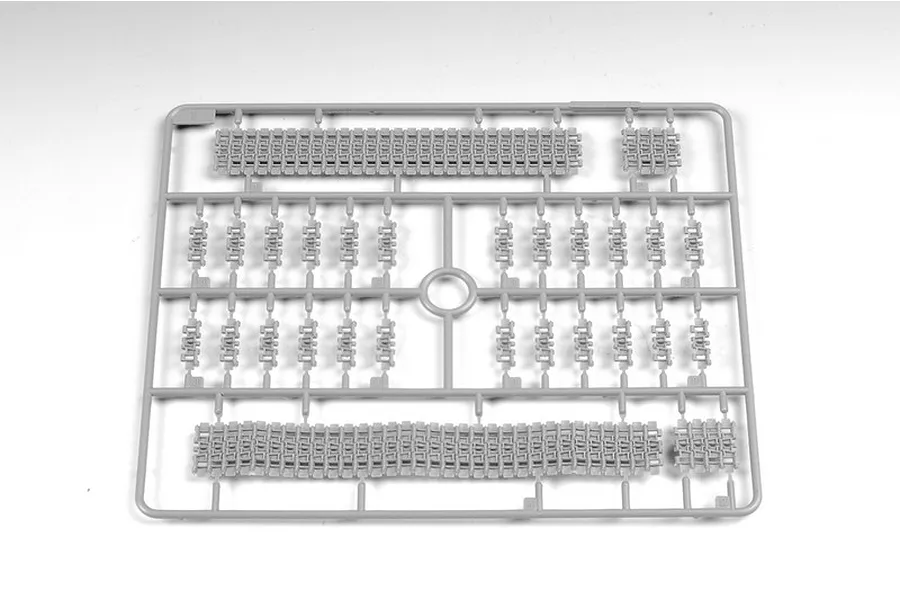A grey plastic sprue containing individual tank track links and track segments for a 1/35 scale model kit.