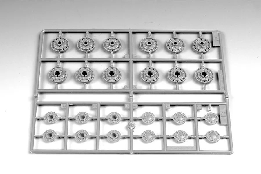 A grey plastic model kit sprue containing various tank road wheels and hub parts for a 1/35 scale model.