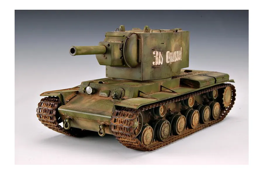 A 1/35 scale plastic model of a Russian KV-2 tank, painted in olive green with weathering effects and Cyrillic text on the turret side.