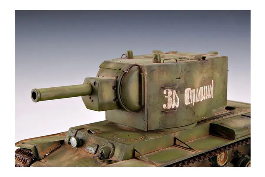 A close-up view of a 1/35 scale model of a Russian KV-2 tank, featuring weathered green paint and Cyrillic text on the turret.