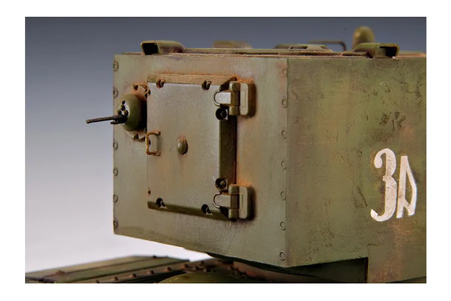 Close-up of a painted scale model KV-2 tank turret with weathered olive green finish and white Cyrillic markings.