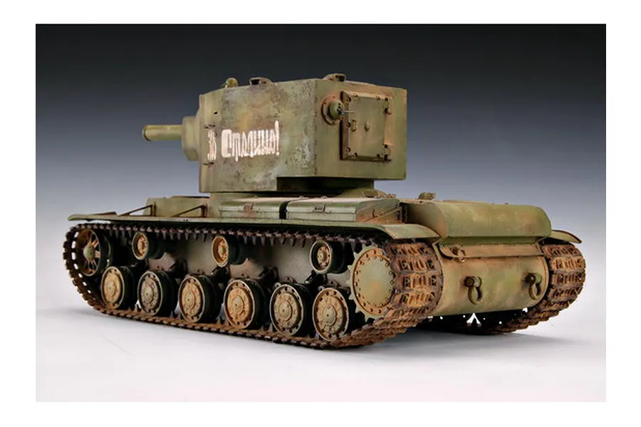 A 1/35 scale plastic model of a Soviet KV-2 tank, painted in olive green with weathering effects and Russian text on the turret.