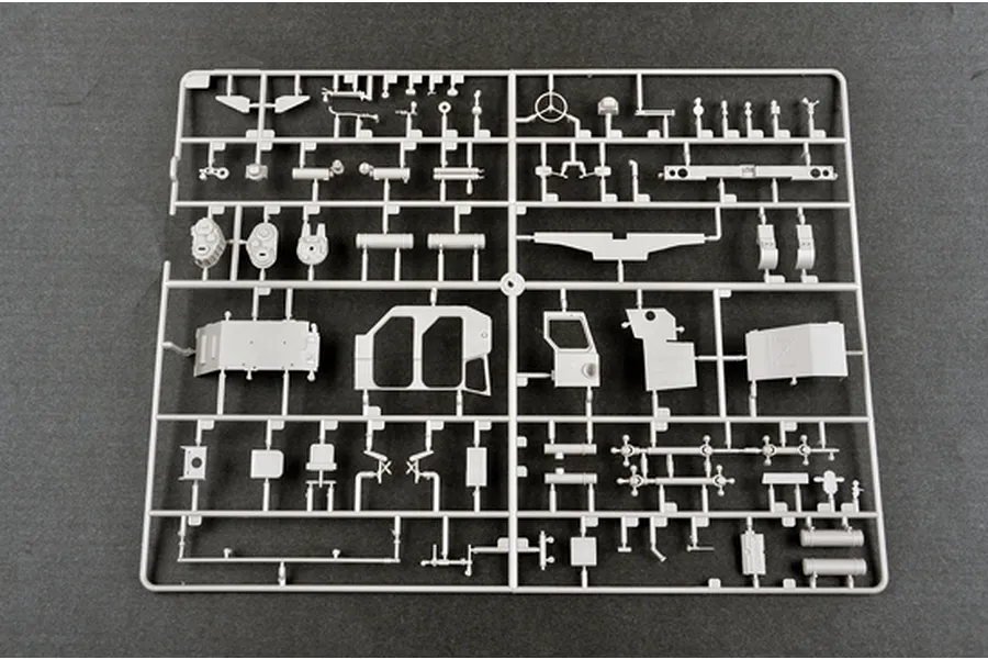 A grey plastic model kit sprue containing various vehicle parts for a 1/35 scale military model.