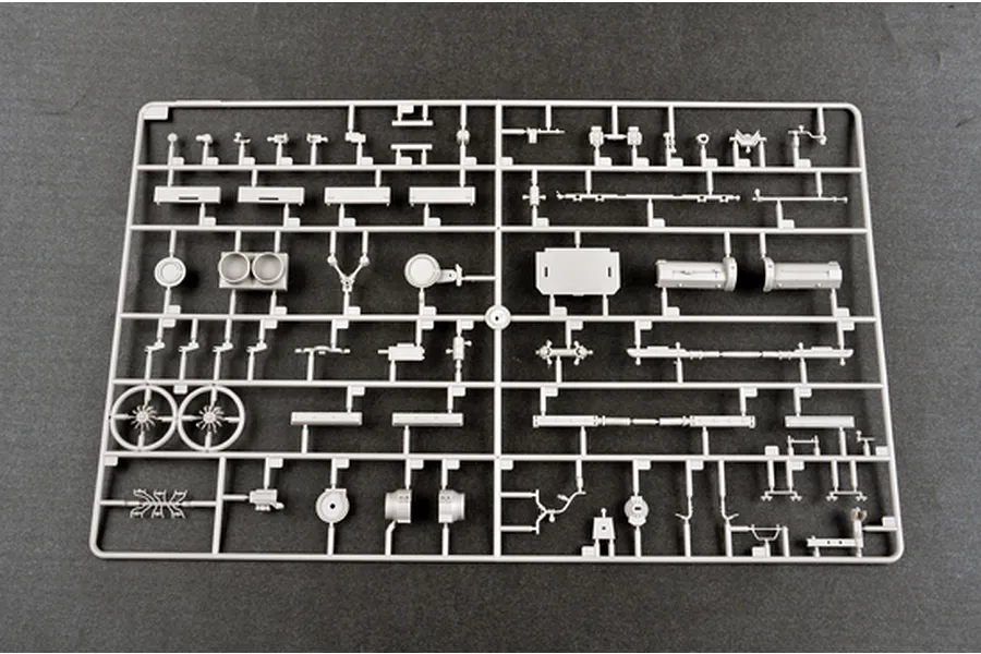 A grey plastic model kit sprue containing various small vehicle parts for a 1/35 scale military model.