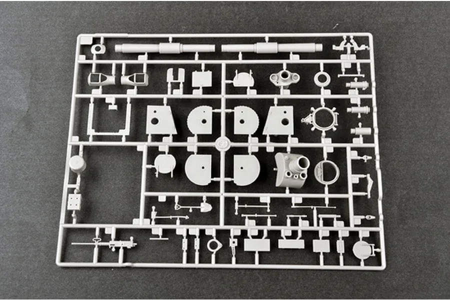 A grey plastic model kit sprue containing various parts for a 1/35 scale military vehicle model, set against a dark grey background.