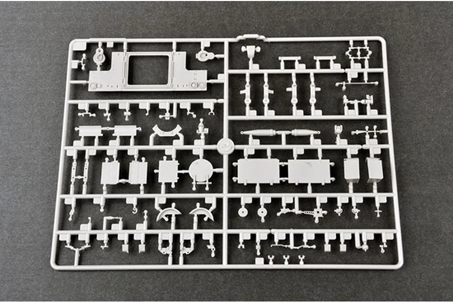 A grey plastic sprue containing various small parts for a 1/35 scale military model kit, laid out on a dark grey surface.