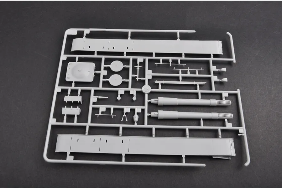 A grey plastic sprue from a Trumpeter 1/35 scale model kit containing tank parts like side panels and barrel components.