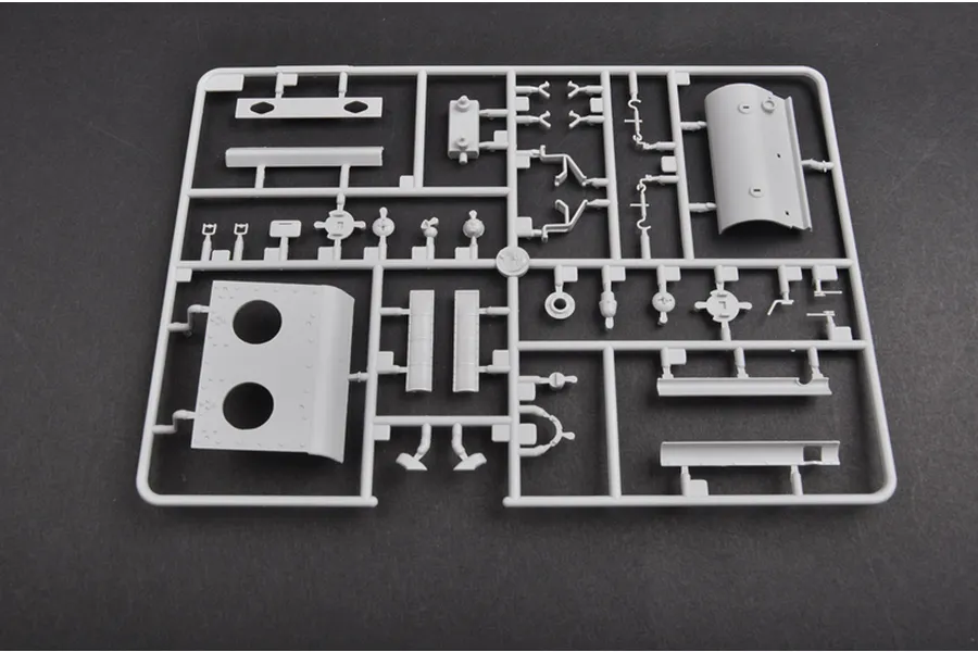 A grey plastic sprue containing various unpainted model tank parts for a 1/35 scale military vehicle kit.
