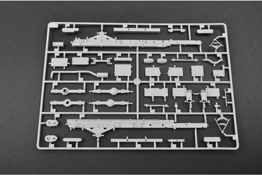 A grey plastic sprue from a Trumpeter 1/35 scale model kit containing various chassis and suspension parts for a military truck.