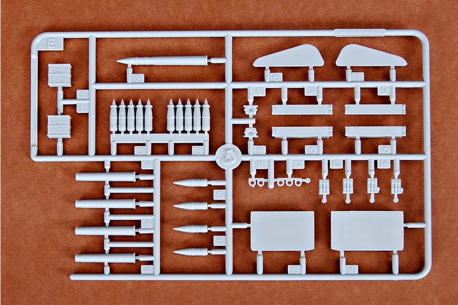 A grey plastic sprue from a Trumpeter 1/35 scale model kit containing various ammunition and small vehicle parts.