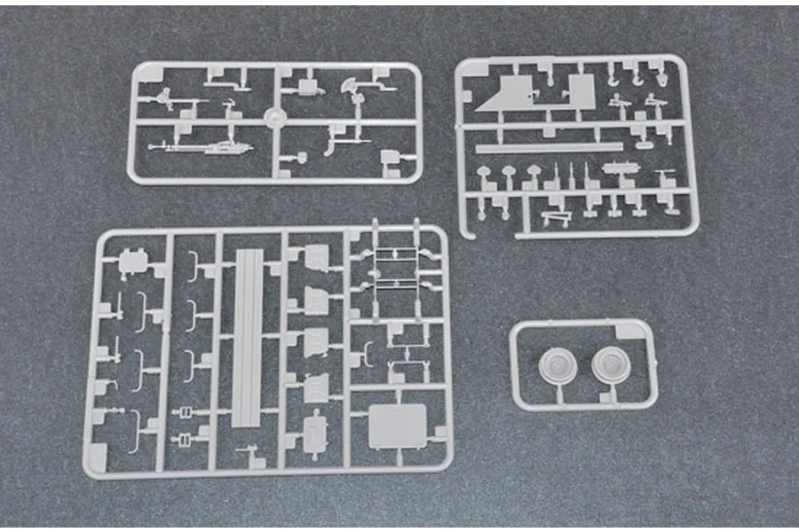 Four grey plastic model kit sprues containing various vehicle parts for a 1/35 scale BTR-60PA model.