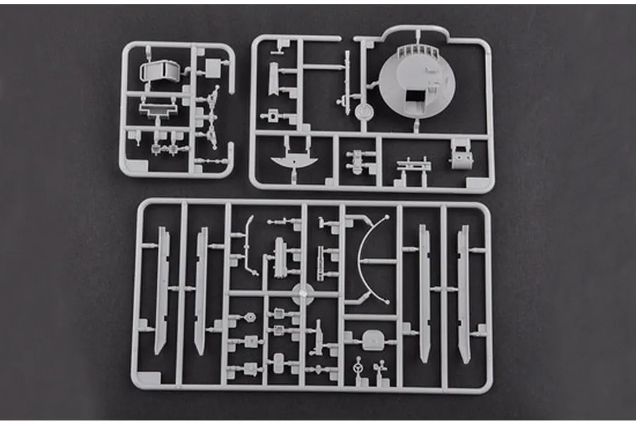 Three grey plastic model kit sprues containing various vehicle parts for a 1/35 scale military model kit.