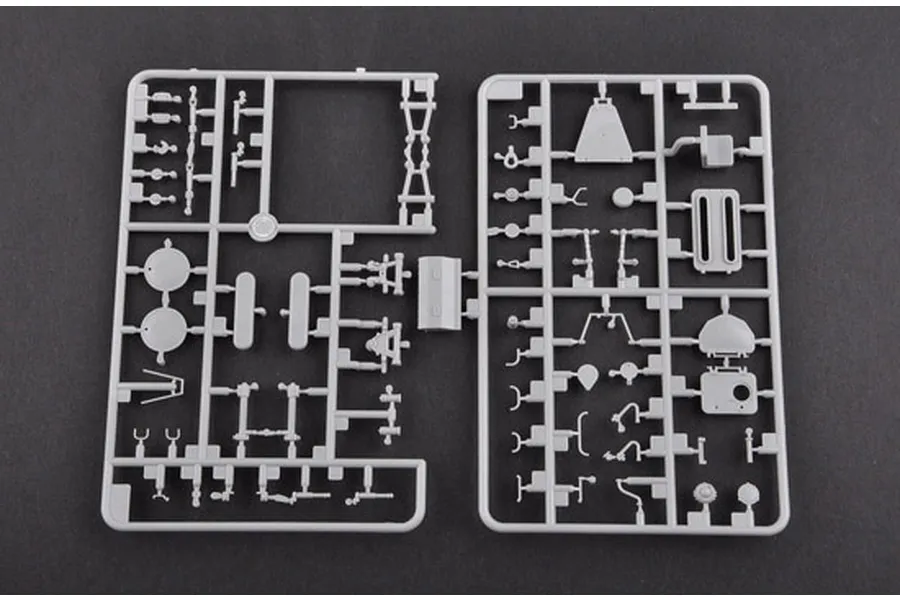 A grey plastic sprue containing various small model parts for a 1/35 scale military vehicle kit.