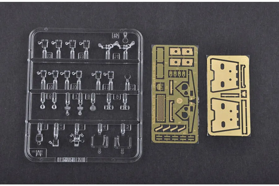 A clear plastic sprue of small model parts and two photo-etched brass detail sheets for a Trumpeter 1/35 BTR-80 model kit.
