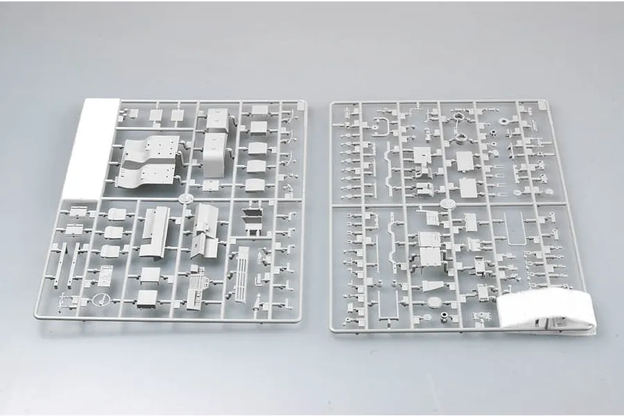 Two grey plastic model kit sprues containing various vehicle parts for a 1/35 scale military truck model.