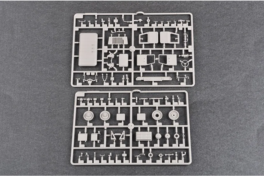 Two grey plastic model kit sprues containing various truck parts for a 1/35 scale model.