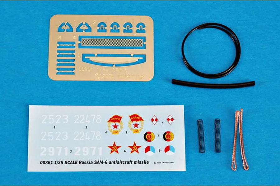 A set of photo-etched parts, decals, wire, and springs for the Trumpeter 1/35 Russian SAM-6 model kit on a blue background.