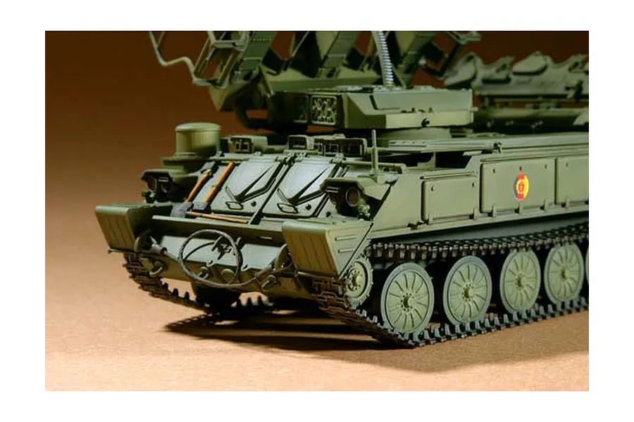 Close-up of a 1/35 scale plastic model of a Russian SAM-6 anti-aircraft missile vehicle, showing the front hull, tracks, and missile launcher assembly.