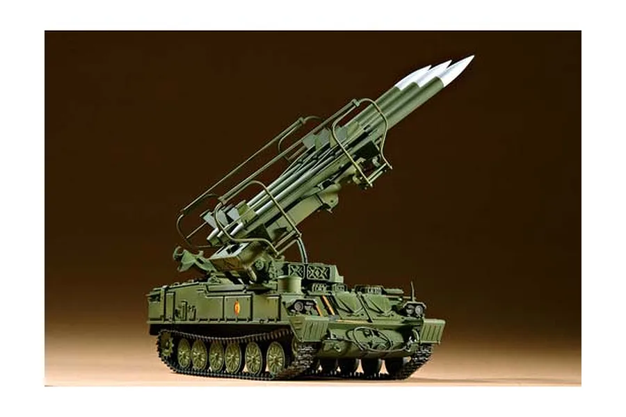 A 1/35 scale plastic model of a Russian SAM-6 anti-aircraft missile system, painted in olive green with three missiles mounted on the launcher.
