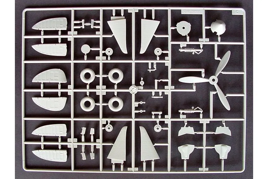 A grey plastic sprue from a Trumpeter 1/32 scale MiG-3 model kit, featuring various aircraft parts like propeller blades, wheels, and wing sections.