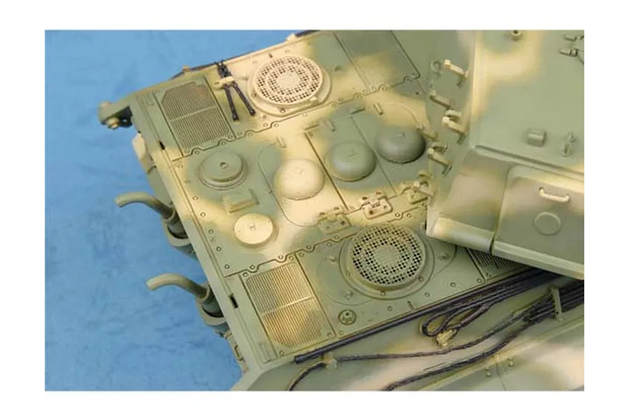 Top-down view of a scale model tank deck showing engine vents, hatches, and camouflage paint.