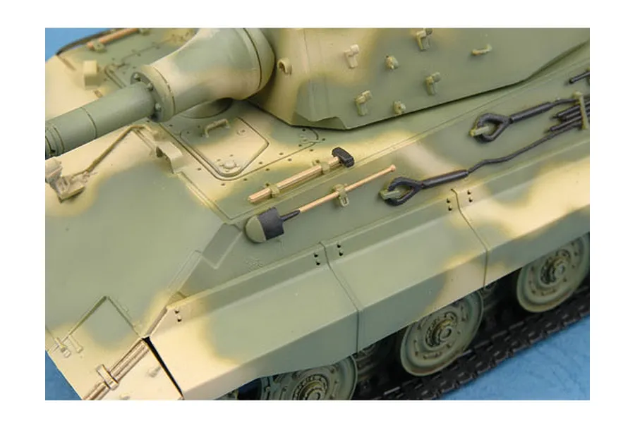 Close-up of a 1/35 scale German E-75 tank model showing the hull, turret, and mounted tools with a green and tan camouflage paint scheme.