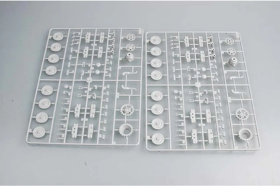 Two identical grey plastic sprues for a 1/35 scale model kit, featuring various tank wheels, sprockets, and small mechanical components.