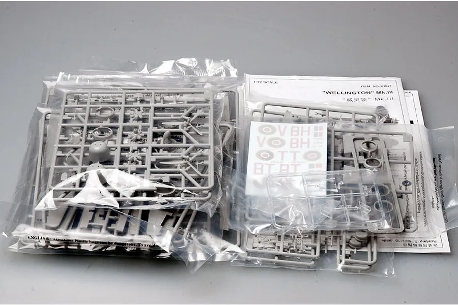 Trumpeter 1/72 scale Wellington Mk.III model kit contents including grey plastic sprues, clear parts, decal sheet, and instruction manual in plastic bags.