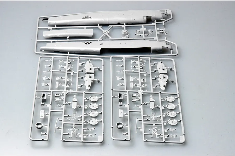 Three grey plastic model kit sprues for a 1/72 scale Wellington bomber, showing fuselage halves and various small aircraft components.