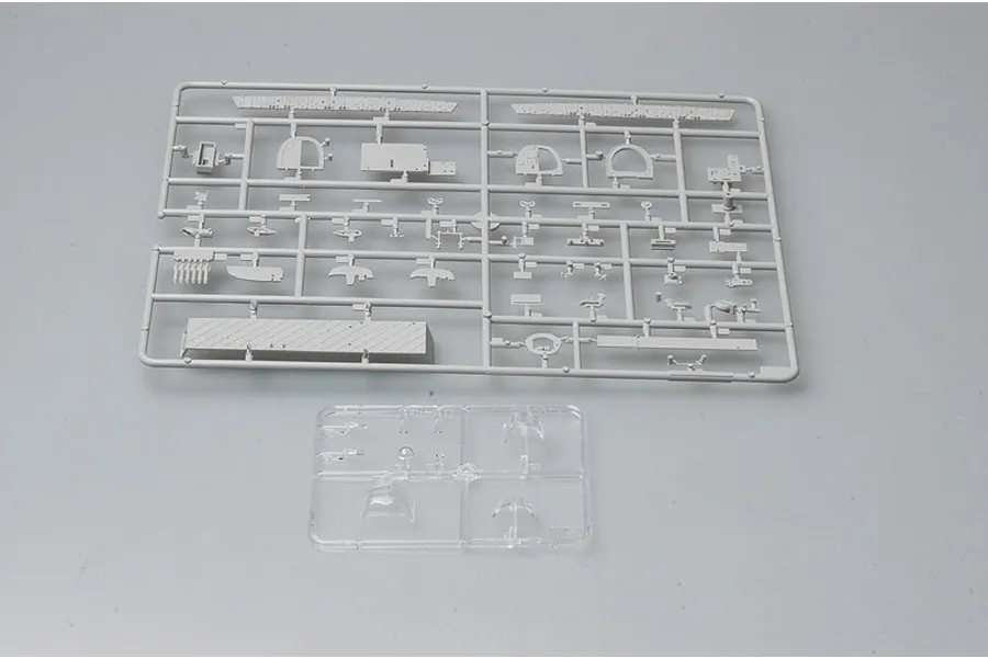 Two plastic model kit sprues for a Trumpeter Wellington bomber, one grey and one clear, on a neutral background.