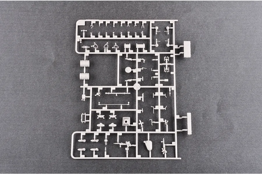 A grey plastic sprue containing various small parts for a 1/35 scale model tank kit, viewed from directly above against a dark grey background.