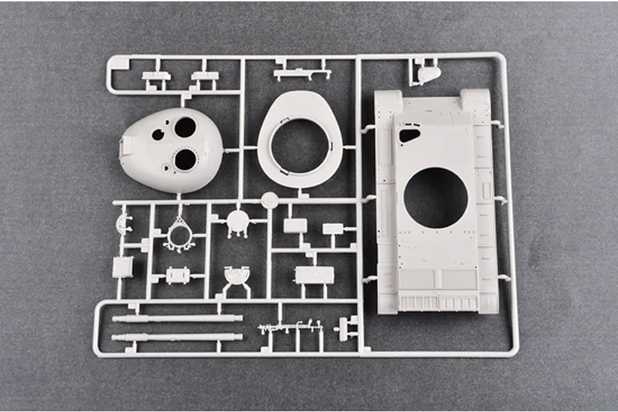A grey plastic sprue from a 1/35 scale model kit containing tank parts including the turret, hull, and gun barrel.