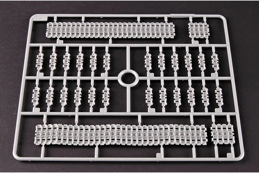 A grey plastic sprue containing individual tank track links and track segments for a 1/35 scale model kit.
