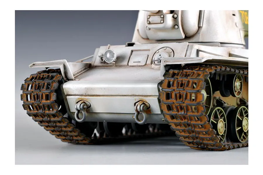 Close-up of the front of a weathered KV-1 tank model kit showing tracks, hull, and turret.