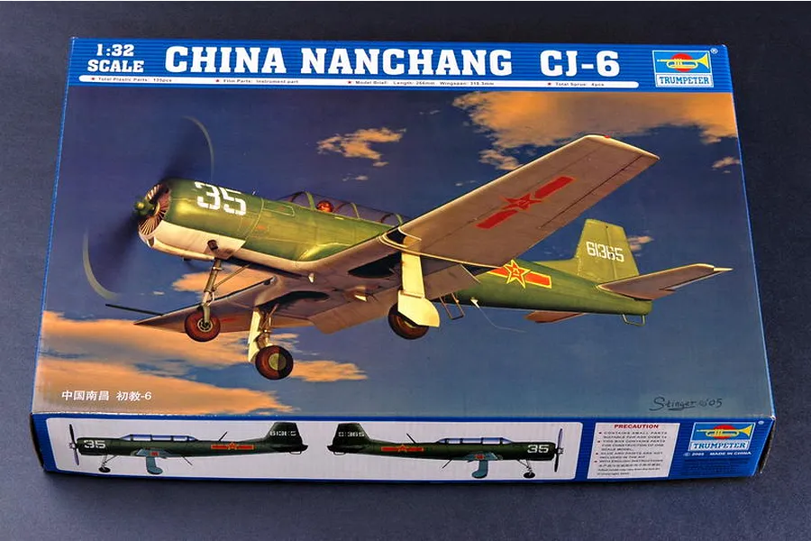 Trumpeter 1/32 scale Nanchang CJ-6 model aircraft kit box showing a green trainer plane in flight against a sunset sky.