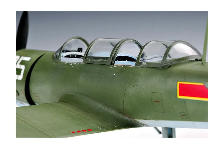 Close-up of a 1/32 scale Nanchang CJ-6 model aircraft showing the cockpit canopy and olive green fuselage.