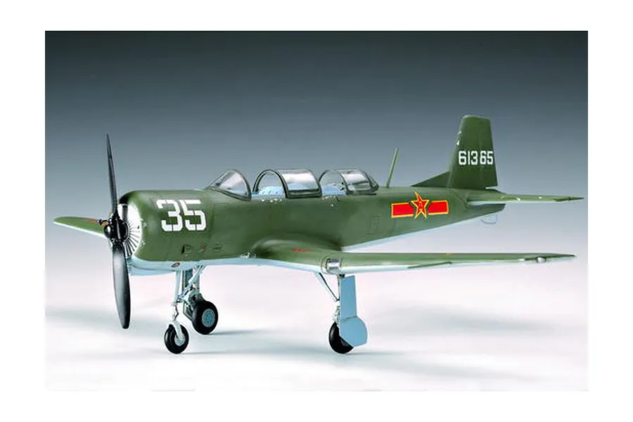 A side-profile view of a finished 1/32 scale Nanchang CJ-6 trainer model aircraft, painted in olive green with Chinese military markings.