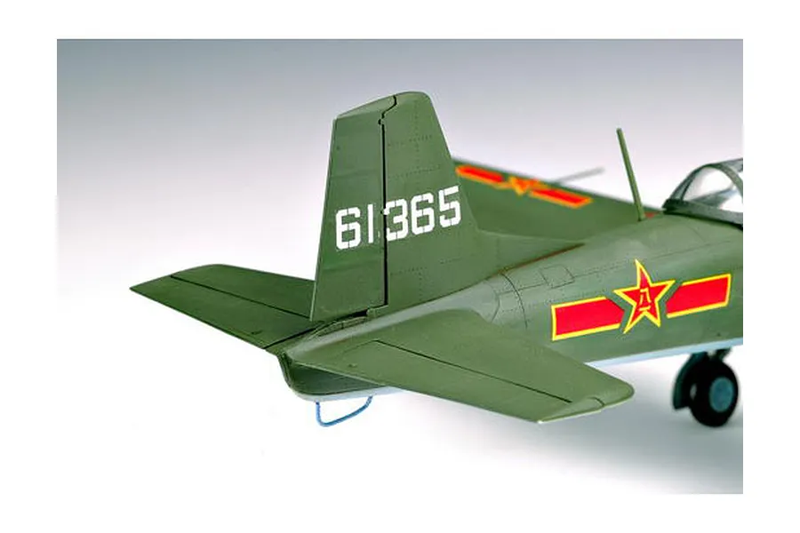 Close-up of the tail section of a 1/32 scale Nanchang CJ-6 model aircraft, featuring olive green paint, white serial number 61365, and red star insignia.