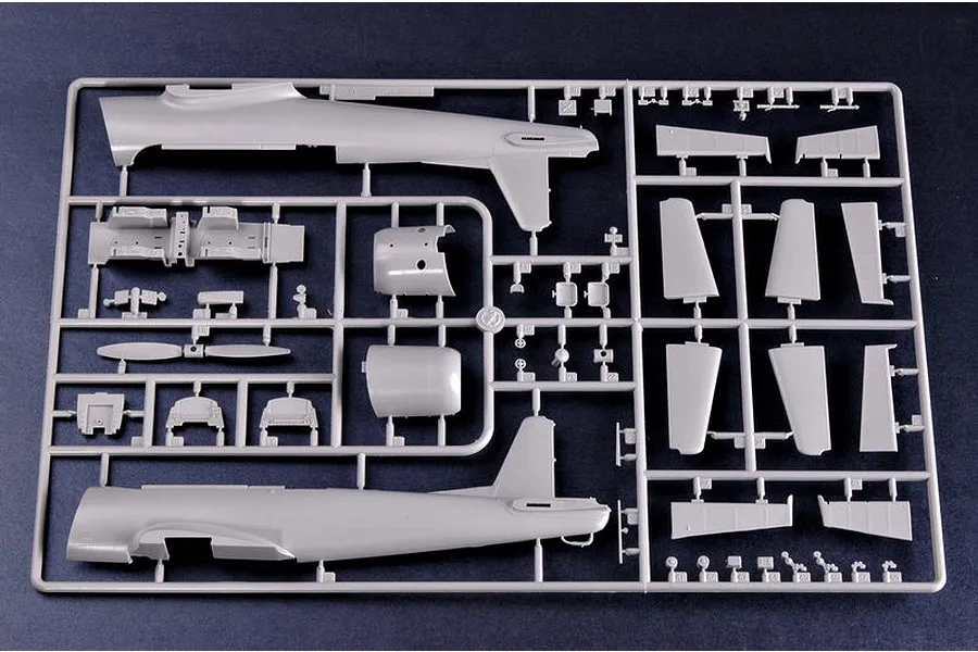 A grey plastic sprue containing various parts for a 1/32 scale Nanchang CJ-6 model aircraft kit, including fuselage halves and wing sections.