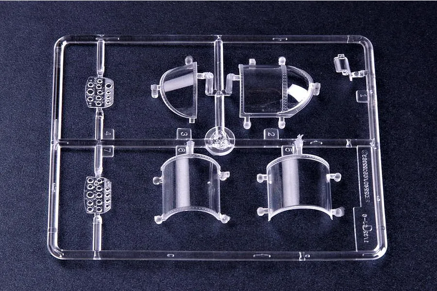 A clear plastic sprue containing canopy and instrument panel parts for a 1/32 scale model aircraft kit.