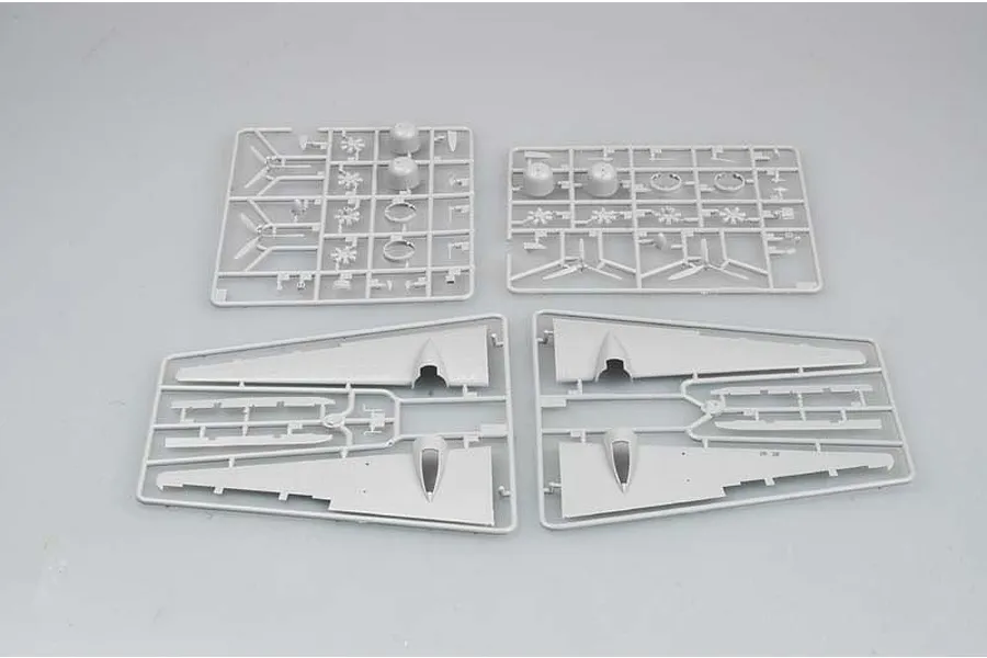Four grey plastic model kit sprues containing aircraft wing and engine parts for a Trumpeter 1/72 scale model.